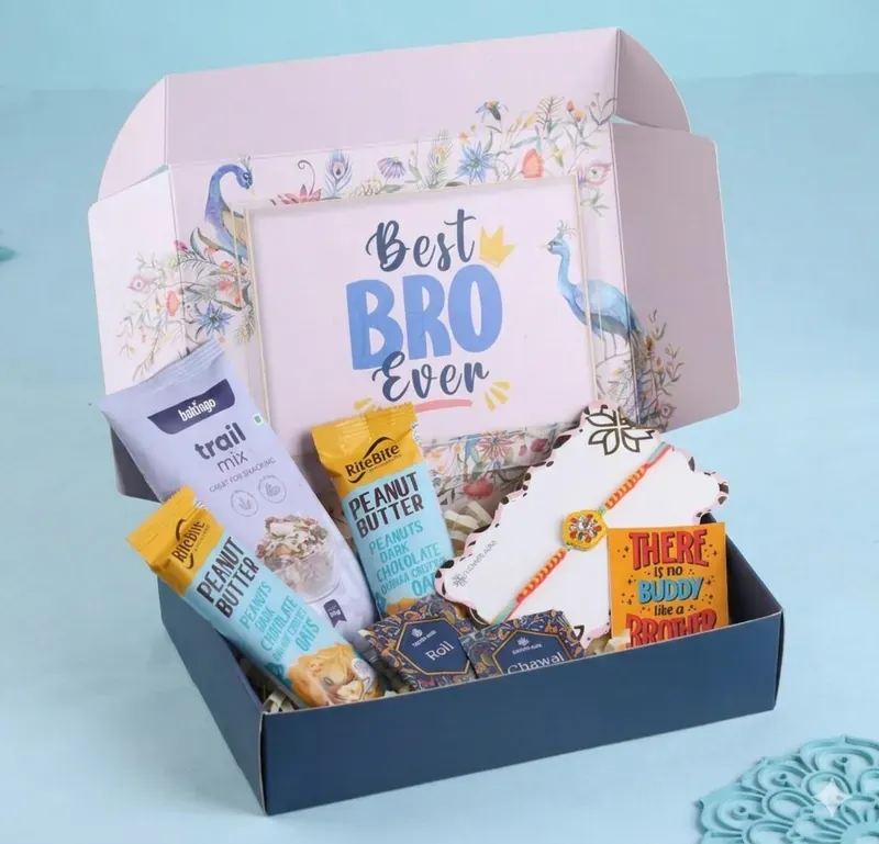 Rakhi Gift Hamper for Brother — Snacks & Sweets Box Close-up of branded Best Bro Ever Rakhi gift box with festive ribbon and premium packaging