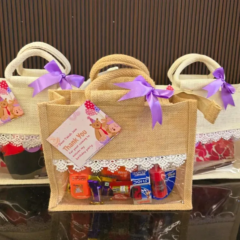 Diwali Jute Bag Gift Hamper — Snacks & Sweets Close-up of festive jute bag hamper contents including premium tea, cookies, and handcrafted chocolates