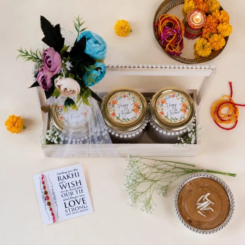 Rakhi Gift Crate — Pinewood Box with Snacks Inside view of floral pinewood Rakhi crate showing hand-painted design and curated gift items