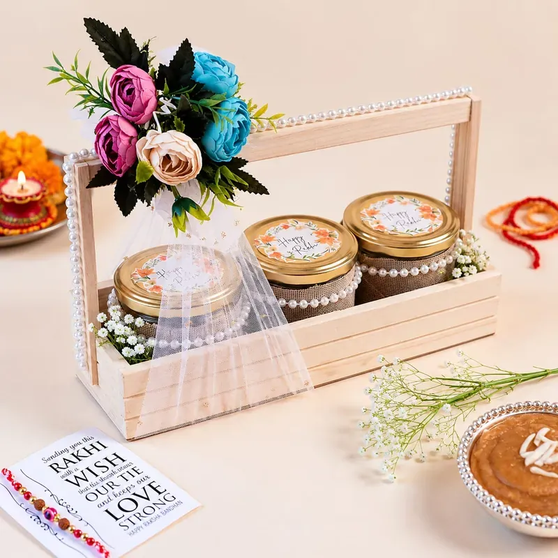 Rakhi Gift Crate — Pinewood Box with Snacks Close-up of floral pinewood Rakhi crate contents including artisanal chocolates and festive sweets